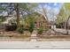 Charming log cabin-style home with a cozy front porch and well-maintained landscaping at 8409 S Otis St, Littleton, CO 80128