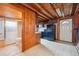 Vintage-style kitchen with wooden cabinets and linoleum flooring next to a full bathroom at 8409 S Otis St, Littleton, CO 80128