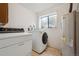 Efficient laundry room with modern washer, dryer, and water heater at 8409 S Otis St, Littleton, CO 80128