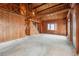 Expansive living area with wooden walls, ceiling beams and a rustic staircase at 8409 S Otis St, Littleton, CO 80128