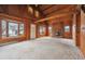 Large living room featuring a fireplace, wood paneling, and multiple windows at 8409 S Otis St, Littleton, CO 80128