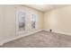 Bedroom featuring neutral colored walls and carpet with two windows and blinds at 723 31St St, Denver, CO 80205