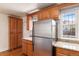 Kitchen featuring stainless steel refrigerator, wood cabinets, and granite countertops at 723 31St St, Denver, CO 80205