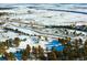 Expansive snowy acreage with a road winding through the landscape at 53 Canyon Pines Dr, Golden, CO 80403