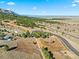 Expansive aerial view of land with trees, road, and surrounding landscape at 53 Canyon Pines Dr, Golden, CO 80403