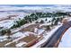 Winter landscape with snow-covered ground and trees, featuring a road winding through the scene at 53 Canyon Pines Dr, Golden, CO 80403
