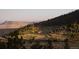 Picturesque landscape featuring rolling hills, lush greenery, and distant mountains under a clear sky at 53 Canyon Pines Dr, Golden, CO 80403