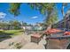 Backyard featuring patio furniture, mature tree, and plenty of space for outdoor enjoyment at 5424 Saulsbury Ct, Arvada, CO 80002