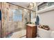 Bathroom featuring tiled shower with glass door, vanity, and modern fixtures at 5424 Saulsbury Ct, Arvada, CO 80002