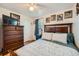 Bedroom showcasing a dresser, hardwood floors, and comfortable bed, creating an inviting atmosphere at 5424 Saulsbury Ct, Arvada, CO 80002