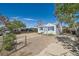 Quaint home with blue trim, gravel yard, and a cozy, inviting exterior perfect for relaxed living at 5424 Saulsbury Ct, Arvada, CO 80002