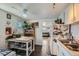 Well-lit kitchen with white cabinets, wooden floors and a view of the living room, creating an inviting space at 5424 Saulsbury Ct, Arvada, CO 80002
