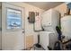 Functional laundry area with washer, dryer, and exterior access, providing convenience and practicality at 5424 Saulsbury Ct, Arvada, CO 80002