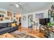 Comfortable living room with hardwood floors, cozy sofa, and an open view into the kitchen area at 5424 Saulsbury Ct, Arvada, CO 80002