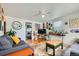 Bright living area with hardwood flooring, comfortable seating, and a view into the adjacent kitchen space at 5424 Saulsbury Ct, Arvada, CO 80002