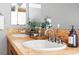 Elegant bathroom with dual sinks, tile accents, and modern fixtures at 425 S Reed St, Lakewood, CO 80226