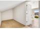 This bedroom has neutral carpet, white walls and a view of the balcony at 425 S Reed St, Lakewood, CO 80226