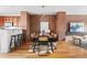 Charming dining room with brick accent wall, chandelier, and seating for six at 425 S Reed St, Lakewood, CO 80226
