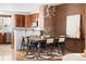 Dining room featuring exposed brick, modern lighting, and seating for six at 425 S Reed St, Lakewood, CO 80226