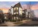 Stunning townhome exterior with brick and modern architectural details at sunset at 425 S Reed St, Lakewood, CO 80226