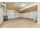 Spacious garage features a large door, concrete floor, and ample storage space, perfect for parking and organization at 425 S Reed St, Lakewood, CO 80226
