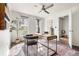 Bright home office with large window, modern desk, and view of hall to entryway at 425 S Reed St, Lakewood, CO 80226