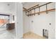 A laundry room with wooden shelving units and connections for a washing machine and dryer at 425 S Reed St, Lakewood, CO 80226