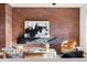 Living room featuring exposed brick wall, modern decor, and comfortable seating at 425 S Reed St, Lakewood, CO 80226