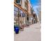Sidewalk view of shopping strip with retail stores featuring glass windows, seating, and modern architectural design at 425 S Reed St, Lakewood, CO 80226