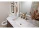 Elegant powder room featuring marble countertop, brushed gold fixtures, and decorative accents at 7600 S Ulster Ct, Centennial, CO 80112