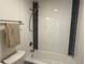 Modern bathroom with a white tiled shower and black accent stripes, complete with sleek fixtures at 7600 S Ulster Ct, Centennial, CO 80112
