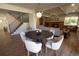 A modern dining room leads to a living room with fireplace and staircase, seamlessly blending living spaces at 7600 S Ulster Ct, Centennial, CO 80112