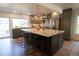 Stylish kitchen with a large granite island, stainless steel appliances, and custom cabinetry at 7600 S Ulster Ct, Centennial, CO 80112