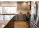 Bright kitchen featuring stainless steel appliances, gray cabinets, and hardwood flooring at 7600 S Ulster Ct, Centennial, CO 80112