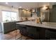 Well-equipped kitchen with granite island, stainless steel appliances, and stylish pendant lighting at 7600 S Ulster Ct, Centennial, CO 80112