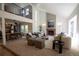 Open concept living room with fireplace, high ceilings and views into the kitchen and upper level at 7600 S Ulster Ct, Centennial, CO 80112
