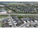 An aerial view captures the community with green spaces, streets and nearby roads and horse facilities at 1624 Pinion Wing Cir, Castle Rock, CO 80108