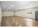 Finished basement with wood-look flooring, recessed lighting, and a window for natural light at 1624 Pinion Wing Cir, Castle Rock, CO 80108