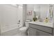 Bright bathroom offers tile floor, shower over tub, and white vanity at 1624 Pinion Wing Cir, Castle Rock, CO 80108