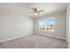 Neutral bedroom with a ceiling fan, large window offering neighborhood views, and plush carpeting at 1624 Pinion Wing Cir, Castle Rock, CO 80108