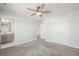 Spacious bedroom with ceiling fan, ensuite bathroom access, and double door closet with white doors at 1624 Pinion Wing Cir, Castle Rock, CO 80108