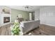 Bright living room features a fireplace, ceiling fan, and wood floors at 1624 Pinion Wing Cir, Castle Rock, CO 80108