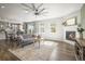 Inviting living room with a fireplace, hardwood floors, and natural light, perfect for relaxation and entertainment at 1624 Pinion Wing Cir, Castle Rock, CO 80108