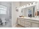 Bright bathroom featuring a vanity with drawers, framed mirror, tile floors, and shower/tub combo at 26642 E Peakview Pl, Aurora, CO 80016