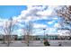 Modern school building with ample parking, set against a backdrop of a bright, cloudy sky, perfect for growing minds at 26642 E Peakview Pl, Aurora, CO 80016