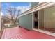 Red painted deck overlooking a lawn through sliding glass doors at 2675 S Deframe Cir, Lakewood, CO 80228