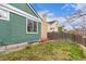 Back exterior of home with a view of a lawn, fence, and trees at 2675 S Deframe Cir, Lakewood, CO 80228