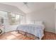 Bright bedroom featuring hardwood floors and a large window at 2675 S Deframe Cir, Lakewood, CO 80228