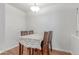 Simple dining area with a wooden table, four chairs, and a white lace tablecloth at 2675 S Deframe Cir, Lakewood, CO 80228