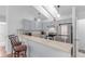Bright kitchen featuring stainless steel appliances, updated cabinets, and a breakfast bar with stool seating at 2675 S Deframe Cir, Lakewood, CO 80228